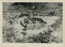 Negative of photograph of hearth at the uMgungundlovu excavation (back view)