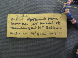Rectangular paper label tied to object