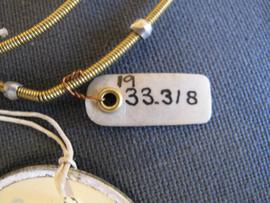 Small oval parchment label tied to object