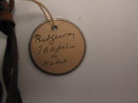 Circular label with metal outline tied to object