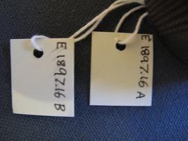 Small recent rectangular paper label tied to object