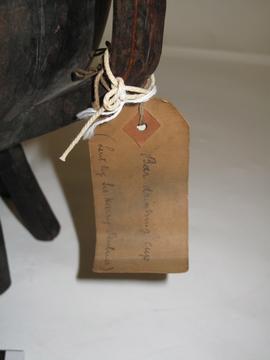 Rectangular brown paper label tied to object