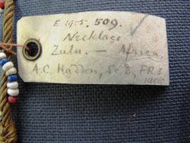 Rectangular parchment label tied to object